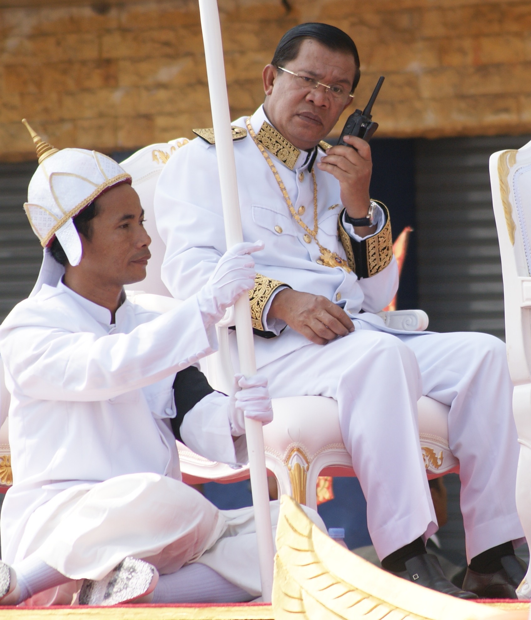 Cambodian Prime Minister Hun Sen Keeps his ears on I-com (2-way police radio) during the procession of Cambodia’s King Father Norodom Sihanouk’s Funeral on Feb 1. (Photo: Chhay Sophal)