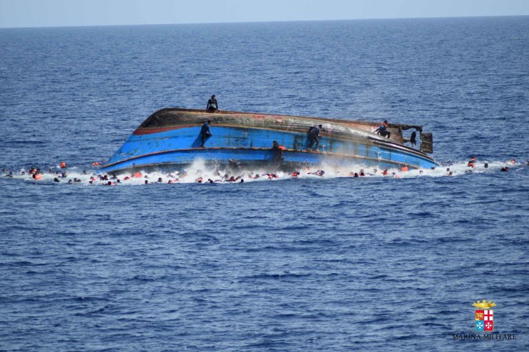 TOPSHOT - This handout picture released on May 25, 2016 by the Italian Navy (Marina Militare) shows the shipwreck of an overcrowded boat of migrants off the Libyan coast today. At least seven migrants have drowned after the heavily overcrowded boat they were sailing on overturned, the Italian navy said. The navy said 500 people had been pulled to safety and seven bodies recovered, but rescue operations were continuing and the death toll could rise. The navy's Bettica patrol boat spotted "a boat in precarious conditions off the coast of Libya with numerous migrants aboard," it said in a statement. / AFP PHOTO / MARINA MILITARE AND AFP PHOTO / STR / RESTRICTED TO EDITORIAL USE - MANDATORY CREDIT "AFP PHOTO / MARINA MILITARE" - NO MARKETING NO ADVERTISING CAMPAIGNS - DISTRIBUTED AS A SERVICE TO CLIENTS STR/AFP/Getty Images